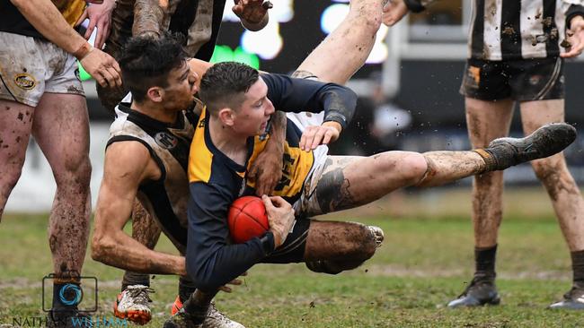 Hurstbridge and Montmorency do battle in wet conditions. Pictures: Nathan McNeill