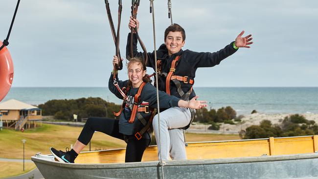 Siblings Caitlyn, 11 Ryan, 13, row a boat in the sky at Mega Adventure Playground. Picture: Matt Loxton