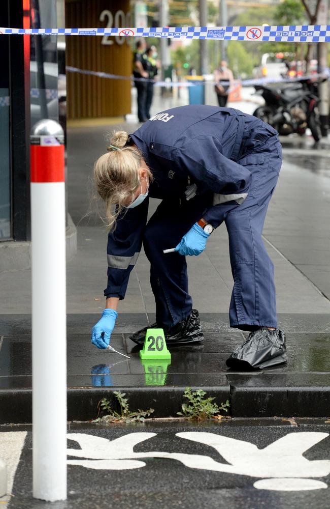 A forensic officer takes evidence. Picture: Andrew Henshaw