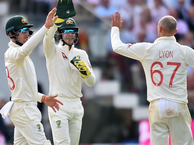 Australia's Nathan Lyon (R) and Australia's captain Tim Paine (C) celebrate the wicket of England's Stuart Broad for 11 runs on the second day of the second Ashes cricket Test match between England and Australia at Lord's Cricket Ground in London on August 15, 2019. (Photo by Glyn KIRK / AFP) / RESTRICTED TO EDITORIAL USE. NO ASSOCIATION WITH DIRECT COMPETITOR OF SPONSOR, PARTNER, OR SUPPLIER OF THE ECB