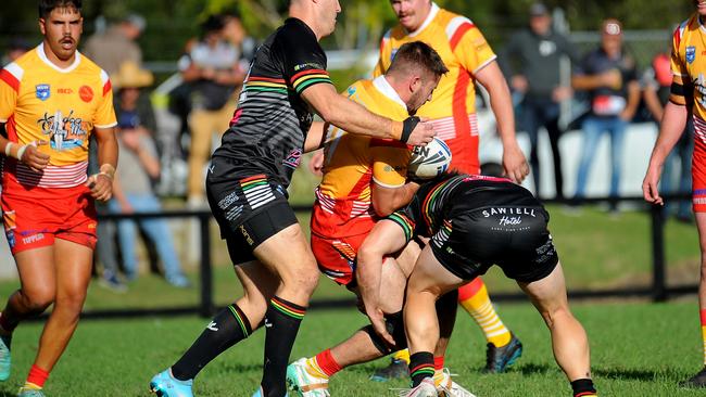 Coffs Harbour forward Justin Hull held in a tackle. Picture: Leigh Jensen