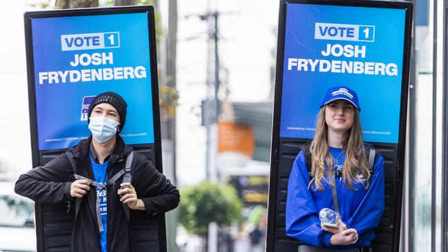 Carrying Coalition hopes on their shoulders, billboard-wearing workers trudge the streets of Hawthorn in Melbourne. Picture: Aaron Francis