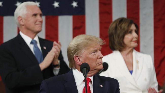 Donald Trump look to the first lady's box before delivering his State of the Union address as Vice President Mike Pence and Speaker Nancy Pelosi look on. Picture: AP.