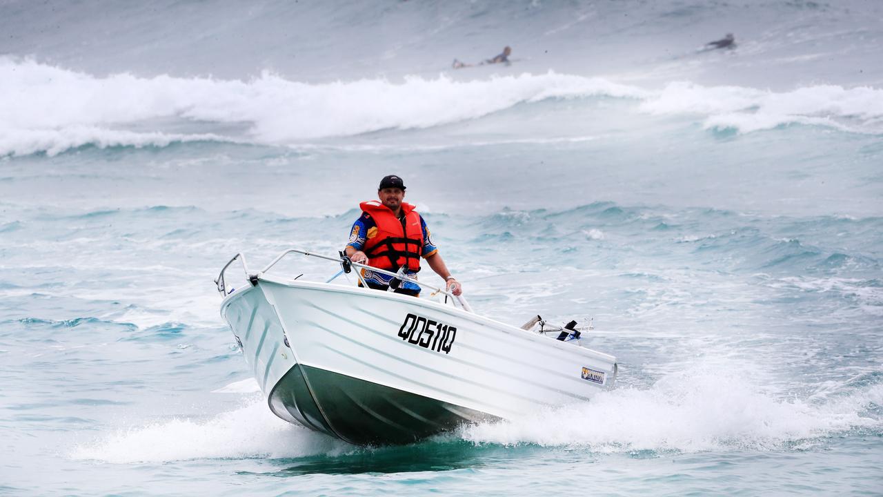 A fisherman braves conditions and crosses the Currumbin Creek bar at Palm Beach this morning as wet weather descended over the Gold Coast. Photo: Scott PowickNEWSCORP