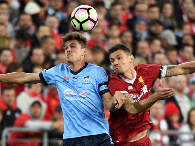 Liverpool player Dejan Lovren vies with Sydney FC rival George Blackwood for possession. Picture: AFP