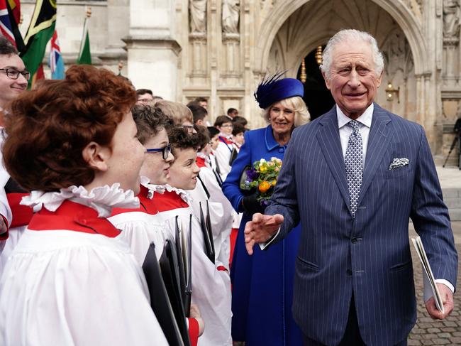 Britain's King Charles III (R) and Britain's Camilla, Queen Consort reacts as they meet with choristers following the Commonwealth Day service ceremony. Picture: AFP