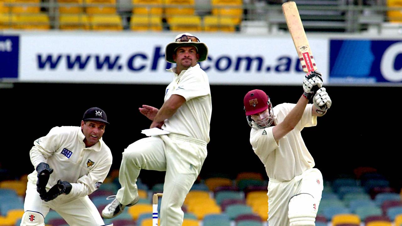 All style - Martin Love drives - that is former Gold Coast batsman Matt Mott leaping at short leg. Mott, once a Shield winning team mate of Love for Queensland, had moved interstate. Pic Patrick Hamilton. Cricket A/CT