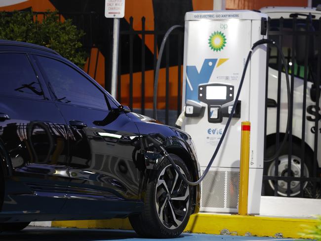 A driver charging his car at an EV charging station in Caringbah. Picture: Jonathan Ng