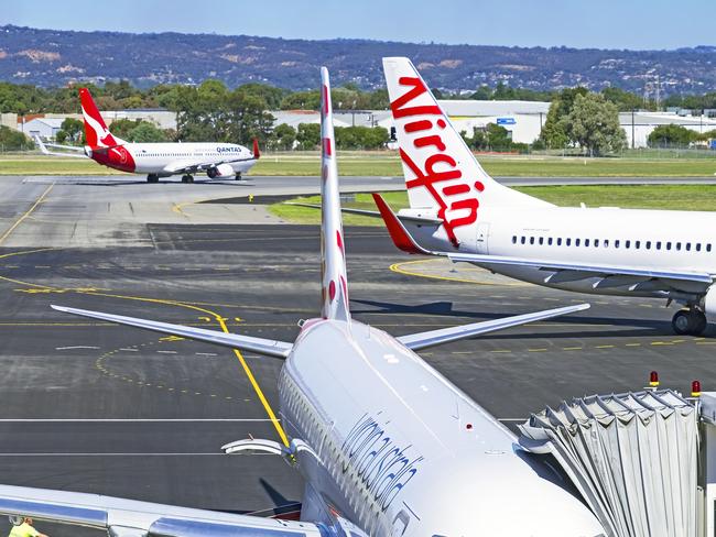 ESCAPE: Adelaide, Australia - March 21, 2016: Planes from domestic air industry competitors and rivals Qantas and Virgin, coming and going from Adelaide airport. Picture: Istock