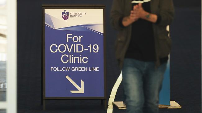 People pass signs for a COVID -19 Clinic at Sydney’s St Vincent’s hospital. Picture: Mark Metcalfe/Getty Images