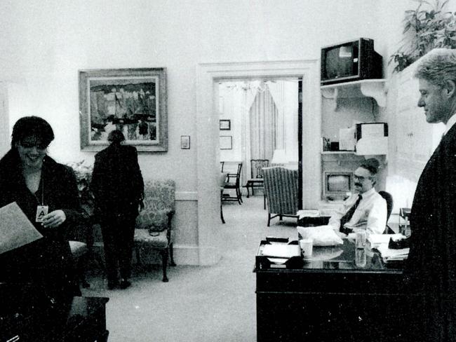 The intern ... Monica Lewinsky (left) working in a White House office as President Bill Clinton looks on.