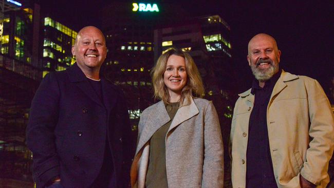 Damian Sargent, RAA senior manager property, Rosa Johnston, RAA senior manager brand and sponsorships, and Ian Widdop, director of sign manufacturers Ecept in front of colourful new RAA signage on top of the former State Bank and Westpac building in the city. Picture: Brenton Edwards