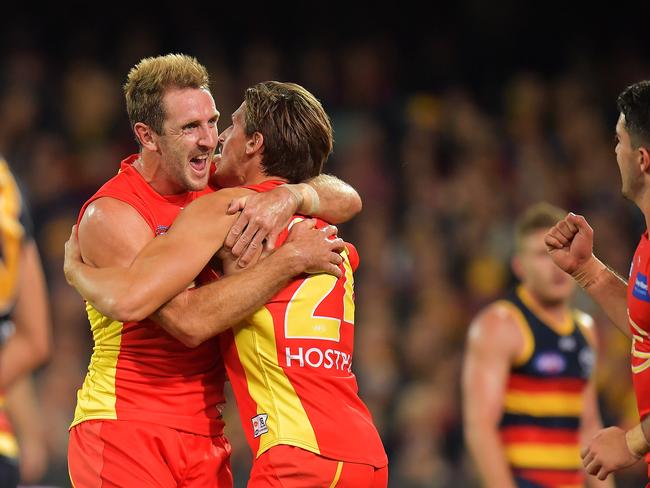 Michael Barlow of the Suns celebrates with David Swallow of the Suns during the round six AFL match between the Adelaide Crows and Gold Coast Suns at Adelaide Oval on April 28, 2018 in Adelaide, Australia. (Photo by Daniel Kalisz/Getty Images)