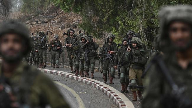 Israeli army soldiers patrol at an undisclosed position in northern Israel near the borer with Lebanon on October 15