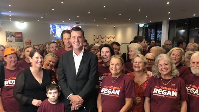 The victorious winning independent candidate in Wakehurst, Michael Regan, flanked by supporters at the Manly Warringah Football Club at Cromer after grabbing the safe seat from the Liberals. Picture: Jim O'Rourke