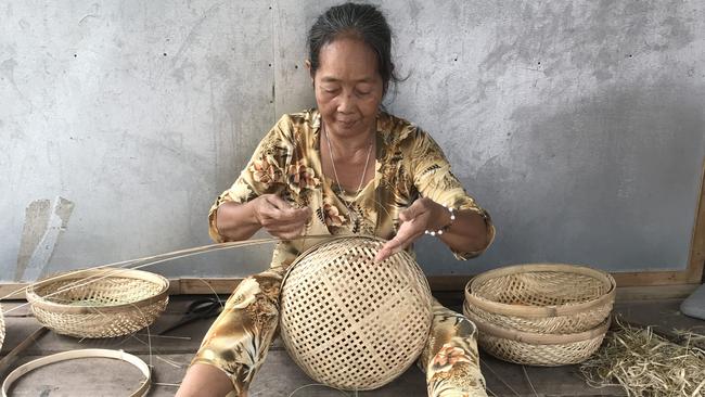 A basket weaver on Con Phuoc, Vietnam, an island in the Mekong. Picture: Penny Hunter