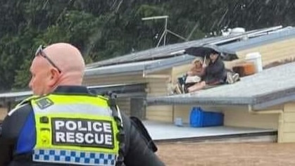 Lismore's Roger Manby, with daughter-in-law Arlene, waiting on his roof in February 2022. Picture: Supplied