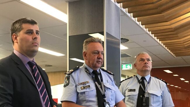 Minister for Police Mark Ryan, Assistant Commander Brian Wilkins and Acting Chief Superintendent Craig Hanlon looking at the new digital technology at DTACC. Photo: Emily Halloran