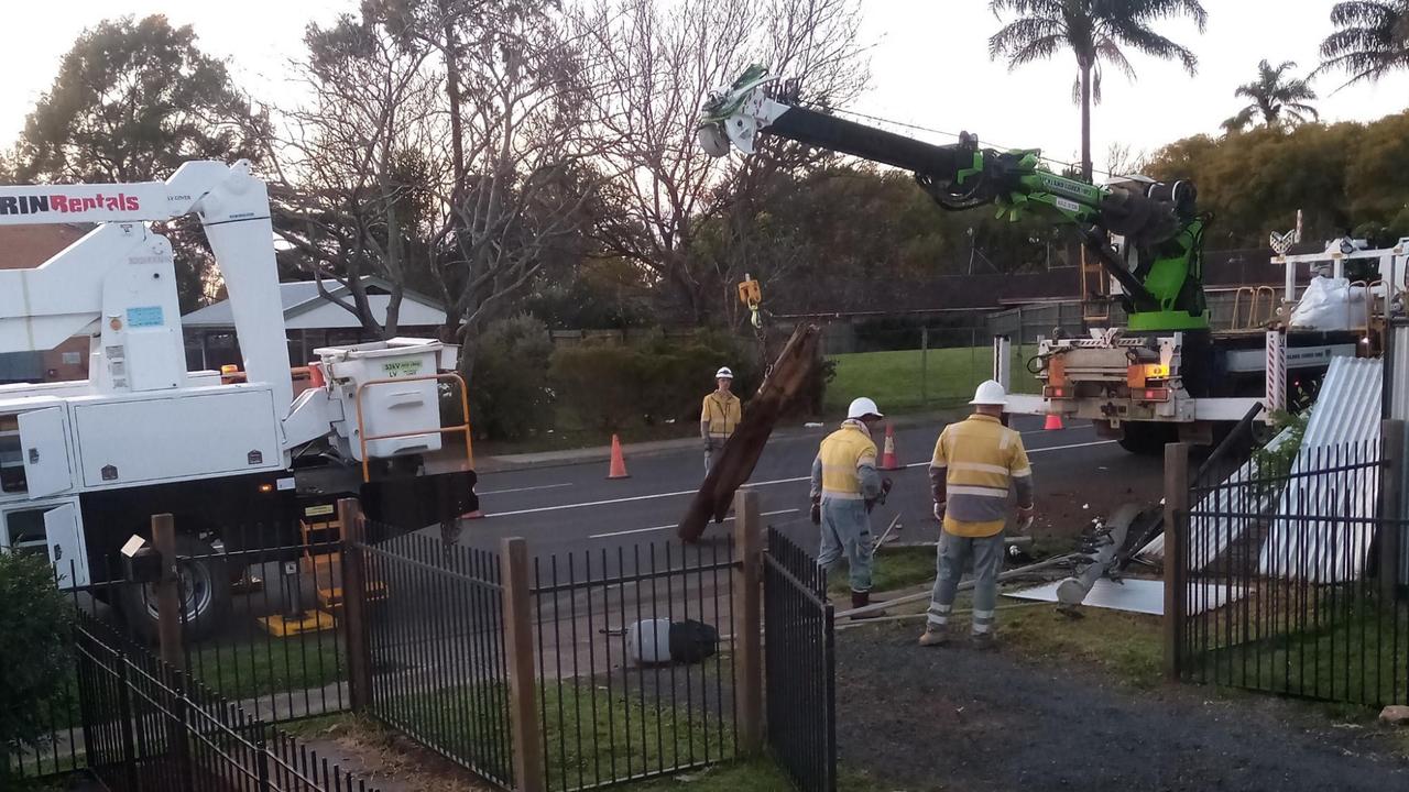 Ergon Energy linesmen replace a power pole after it was snapped in a single-vehicle crash in Tor Street, about 3.20am on Tuesday.