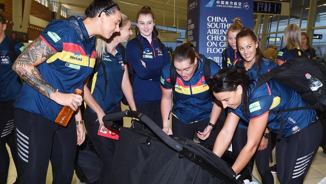 Crows players fuss over Erin Phillips’ twins before their departure for Saturday’s AFLW grand final.