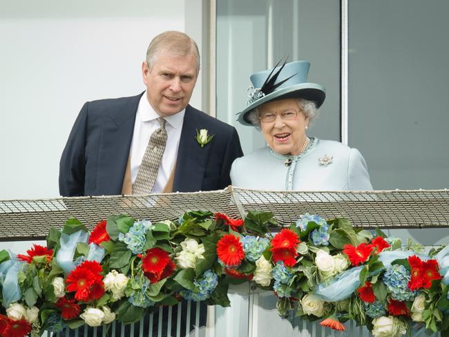 (FILE PIC)  Prince Andrew, the Duke of York (L) speaks to Queen Elizabeth II on the Queens stand during Derby day at the Epsom Derby Festival, in Surrey, southern England, on June 1, 2013. AFP PHOTO/Leon Neal (Photo by LEON NEAL / AFP)