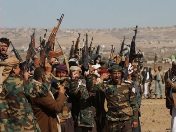 Houthi fighters and tribal supporters hold up their firearms during a protest against recent US-led strikes on Houthi targets, near Sanaa, Yemen. Picture: Supplied