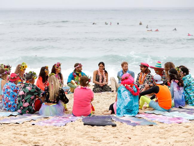 Harry and Meghan talk to members of OneWave at South Bondi Beach. Picture: Getty