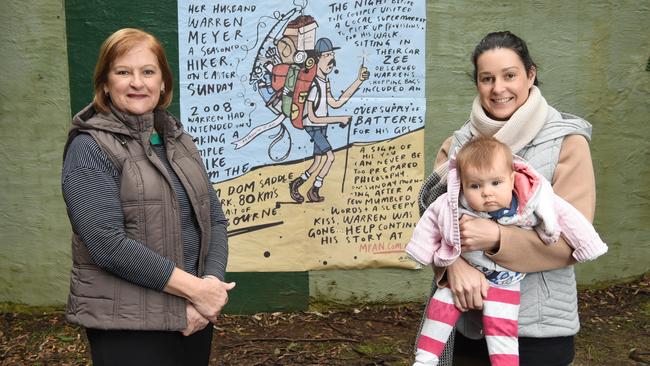 Zee Meyer with her daughter Renee Dowie and her granddaughter, Amelia, with artwork where her husband Warren went missing in 2008. Picture: Lawrence Pinder