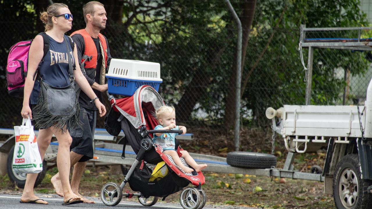 A evacuee family and their pet at the Barron River bridge North Cairns after being rescued by boats following Cyclone Jasper in 2023 Picture: NCA NewsWire / Brian Cassey