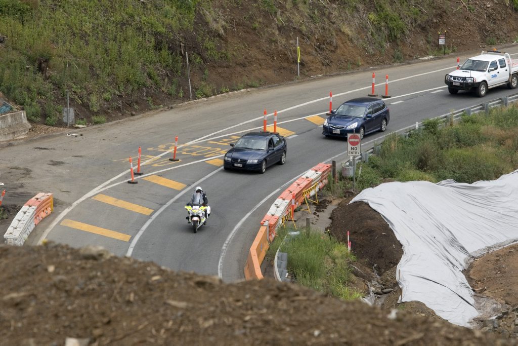 A Queensland Police Service motorcycle officer escorts vehicles on the down-section of the Toowoomba Range. Picture: Kevin Farmer