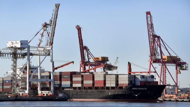 A container ship is pushed to it's berth by a tug at the Port of Melbourne on June 6, 2018. Australia's economy recorded a strong start to the year as exports and business inventories rose, official data showed June 6, but analysts warned soft consumer spending would keep a rise in interest rates at bay. / AFP PHOTO / William WEST