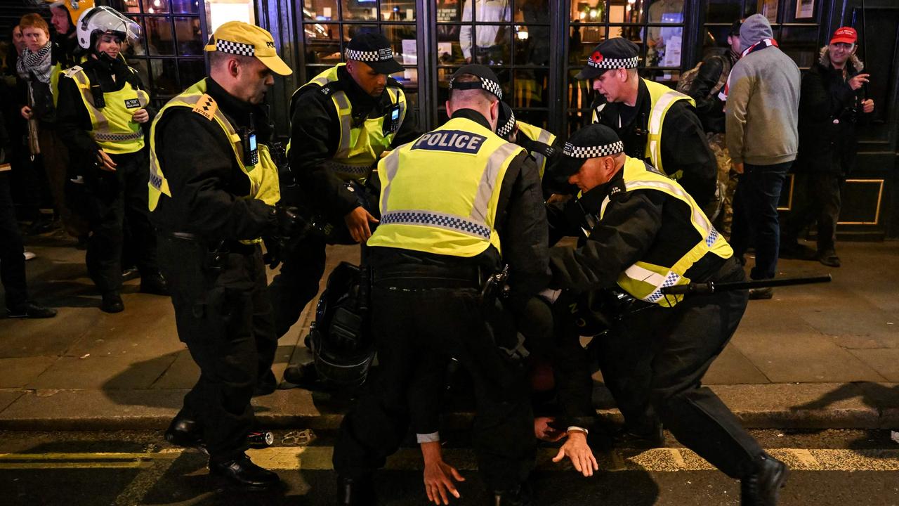 Police officers detain a man in the street by Whitehall close to the National March For Palestine in central London. Picture: AFP