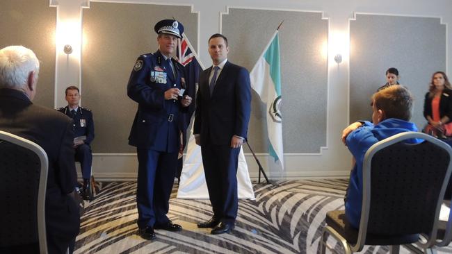 Inspector Stephen Fowler receives a 35 year clasp to his National Medal from Mitchell federal Liberal MP Alex Hawke