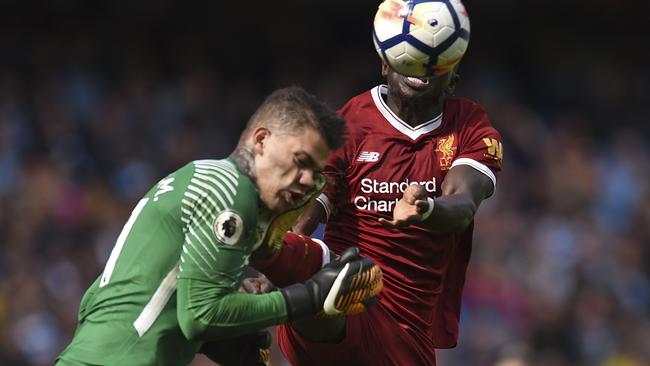 Sadio Mane connects with City's Brazilian goalkeeper Ederson. AFP Photo / Oli Scarff