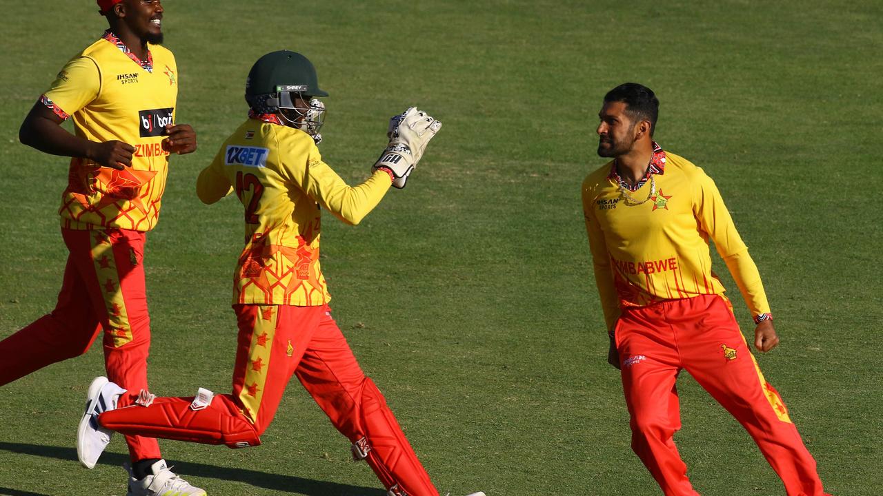 Zimbabwe's Sikandar Raza celebrates with teammates. Photo by Jekesai NJIKIZANA / AFP