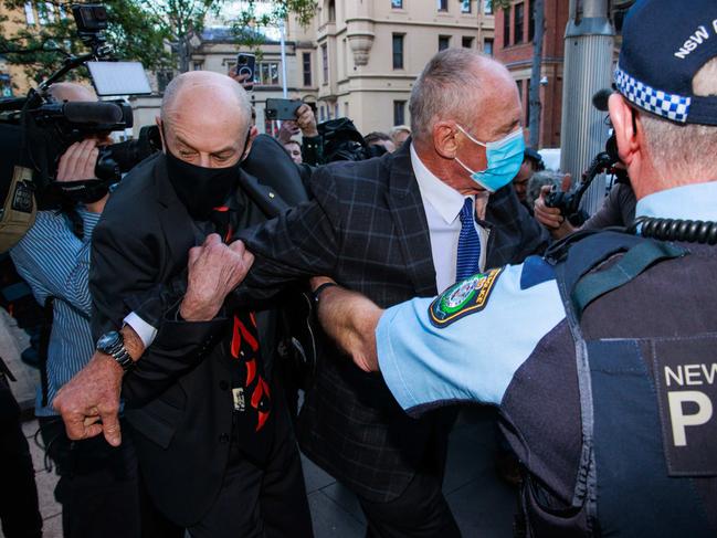 Daily Telegraph. 30, August, 2022.Peter and Paul Dawson are restrained by police after a scuffle with media as they leave the Supreme Court, Sydney, after a guilty verdict was passed down in their brother, Chris DawsonÃs, murder trial, today.  Picture: Justin Lloyd.