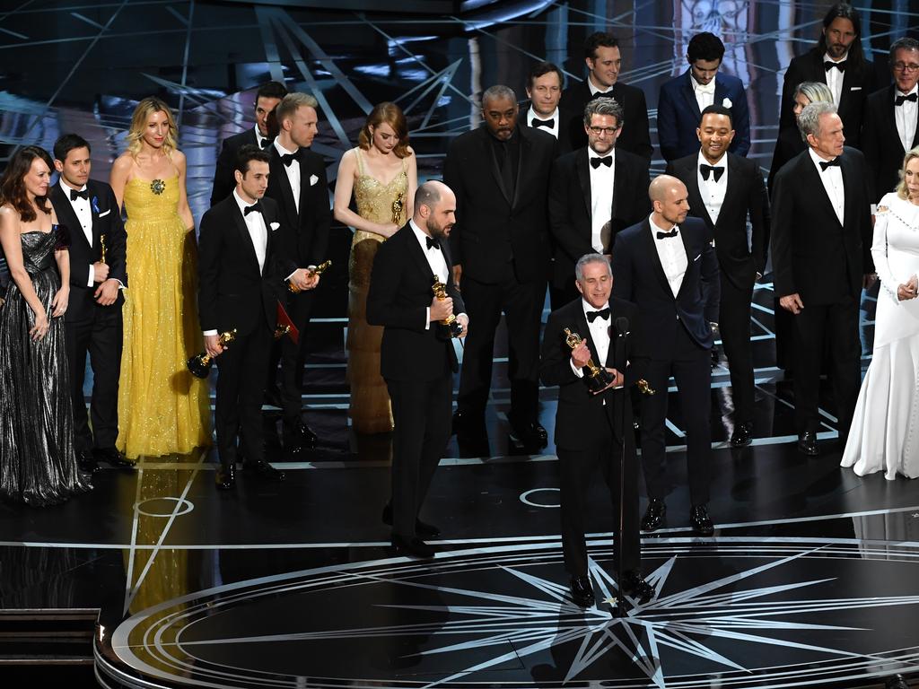 Prior to learning of a presentation error, ‘La La Land’ producers Marc Platt (speaking at microphone), Jordan Horowitz and Fred Berger accept the Best Picture award for ‘La La Land’ (later awarded to actual Best Picture winner ‘Moonlight’) onstage during the 89th Annual Academy Awards. Picture: Getty