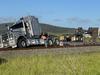 Semi-trailer lands on train line after Bruce Hwy crash
