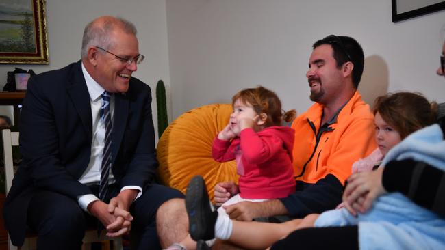 Prime Minister Scott Morrison meets prospective new home buyers Danielle and Christopher Stephens and their children Zayne (2 weeks old), Gabriella (2yrs) and Kelsey (6yrs) during a visit to the home of new homeowners Lachlan Kowaleski and Katie Macqueen in Jamisontown.