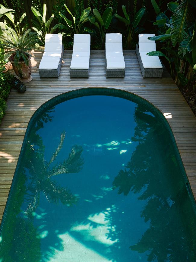 The curved pool accentuates the home’s tropical vibe. Picture: Earl Carter