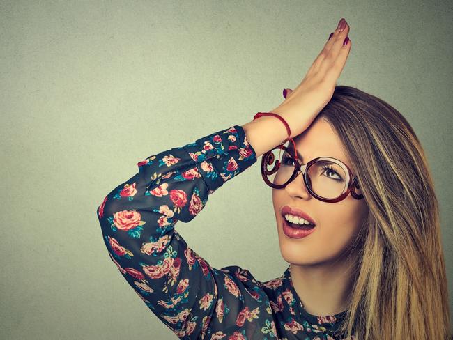 Regrets wrong doing. Closeup portrait silly young woman, slapping hand on head having duh moment isolated on gray background. Negative human emotion facial expression feeling, body language, reaction, forgetting generic, forgetful s