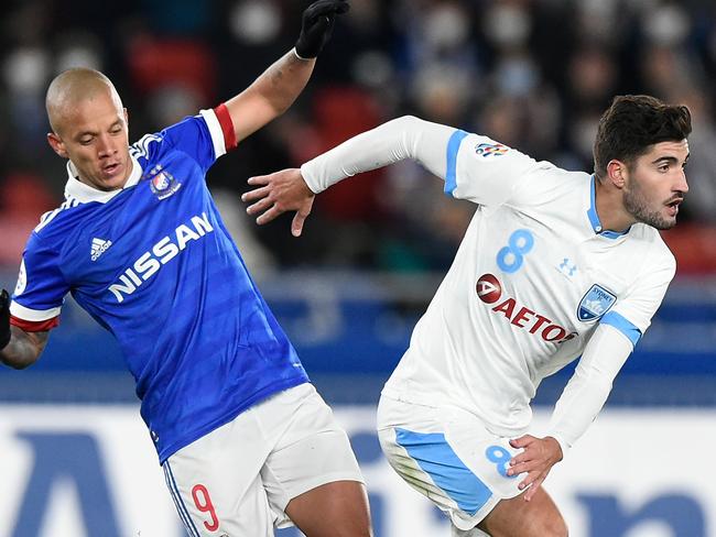 Sydney FC’s Paulo Retre (right) and and Yokohama’s Junior Marcos competed for the ball. Picture: Getty Images