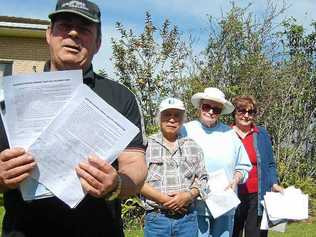 Bill Daniels holds a petition opposed to a new crematorium in Grafton. Supporting him are Peter Lee, Claire Lee and Daphne Batson.