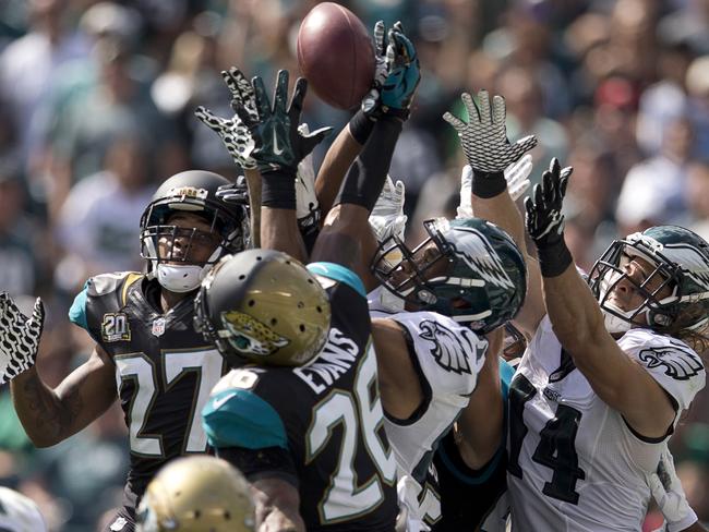 Riley Cooper #14 and Jordan Matthews #81 of the Philadelphia Eagles go up for a hail mary pass as Dwayne Gratz #27 and Josh Evans #29 of the Jacksonville Jaguars defends.
