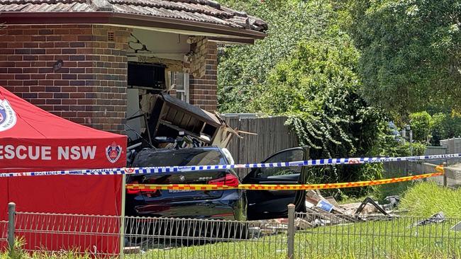 SYDNEY, AUSTRALIA - NewsWire Photos - 13 JANUARY, 2025: A woman has died in a single-vehicle crash in Sydney’s west today. About 10.30am (Monday 13 January 2025), emergency services were called to Punchbowl Road, Belfield, following reports of a crash. Officers attached to Auburn Police Area Command attended and found a vehicle had crashed into a house. The female passenger of the car was trapped for some time before being freed. She was treated at the scene by NSW Ambulance paramedics, however, died at the scene. Picture: NewsWire / Gaye Gerard