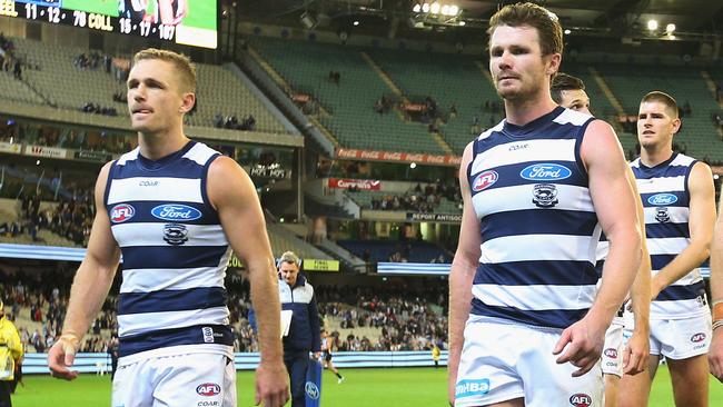 Joel Selwood and Patrick Dangerfield lead the Cats off the MCG.