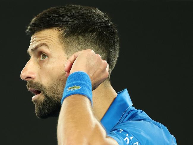 Djokovic gestures to the crowd after his victory. Picture: Cameron Spencer/Getty Images