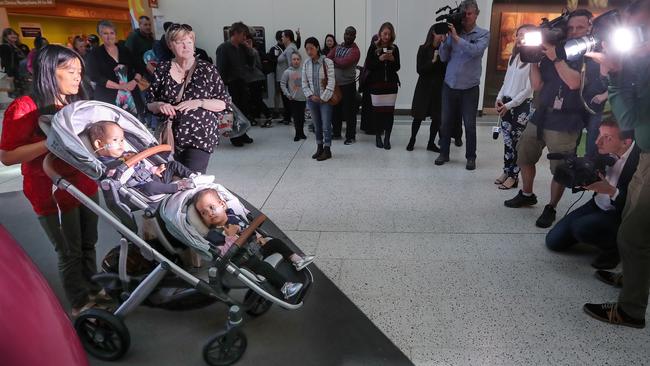 The twins and their mother, Bhumchu Zangmo, front the media on their way out of the hospital. Picture: Alex Coppel.