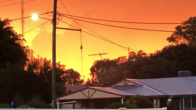 The vibrant orange sun in the sky as seen from Gracemere following wild storms across Central Queensland on Sunday, January 12.