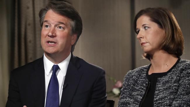 Brett Kavanaugh, with his wife Ashley Estes Kavanaugh, answers questions during a FOX News interview, Monday, Sept. 24, 2018, in Washington, about allegations of sexual misconduct against the Supreme Court nominee. (AP Photo/Jacquelyn Martin)